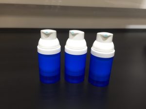 Three blue bottles on a table