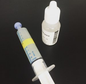 A bottle of medicine and a syringe