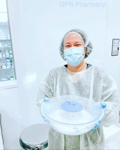 Woman in lab coat holding a dish